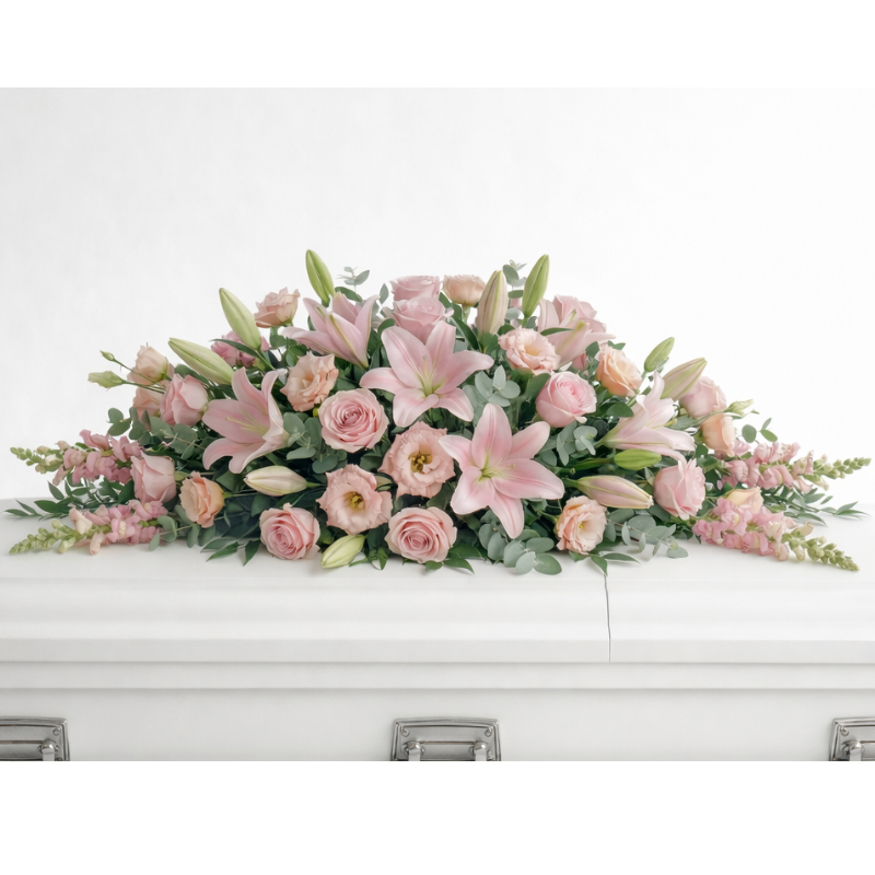 Blush Tribute Casket Flowers - Pink roses, lilies and snapdragons casket arrangement
