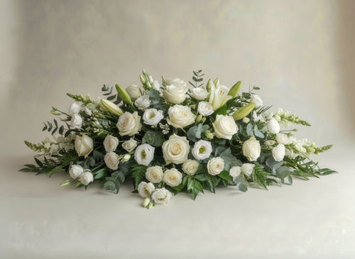 Signature Neutrals casket spray featuring premium white roses, snapdragons, lisianthus and lilies